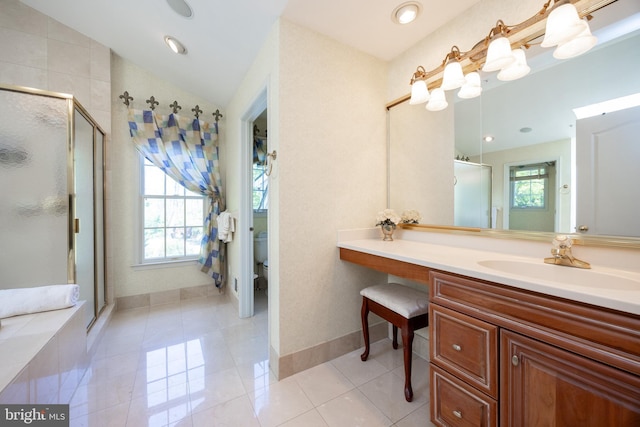full bath featuring toilet, vanity, a stall shower, tile patterned flooring, and baseboards