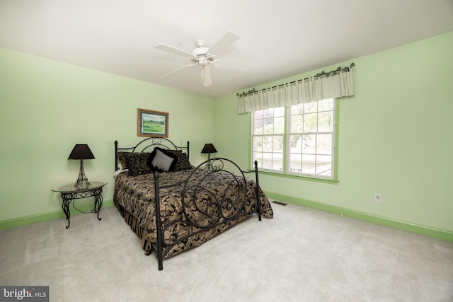 bedroom featuring carpet, visible vents, baseboards, and ceiling fan