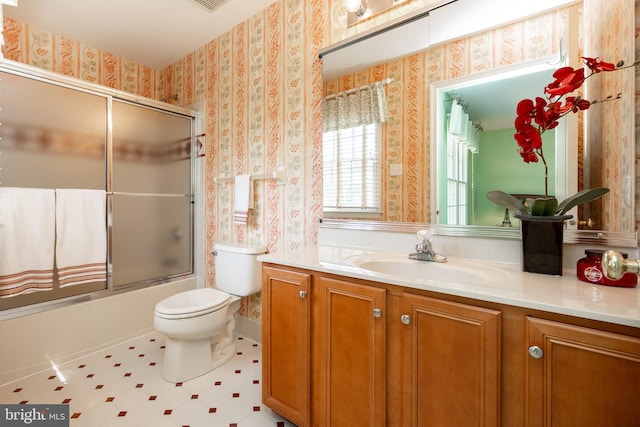 full bath with vanity, toilet, shower / bath combination with glass door, and wallpapered walls