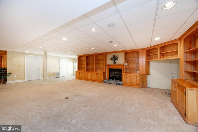 unfurnished living room featuring carpet, built in features, a fireplace with raised hearth, and recessed lighting