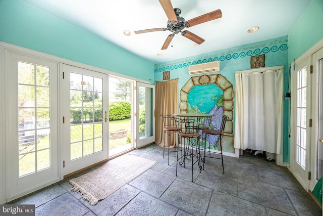 sunroom / solarium with a wealth of natural light, french doors, and stone tile floors