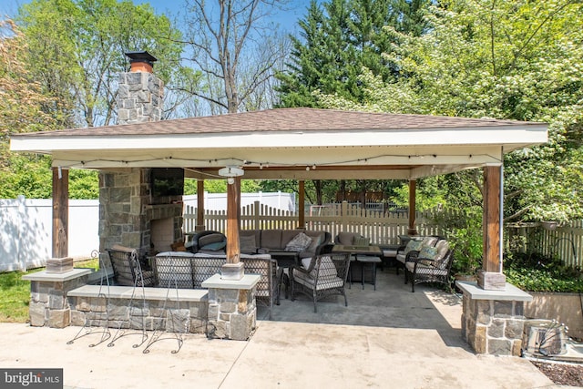 view of patio / terrace with a fenced backyard, a gazebo, and an outdoor living space