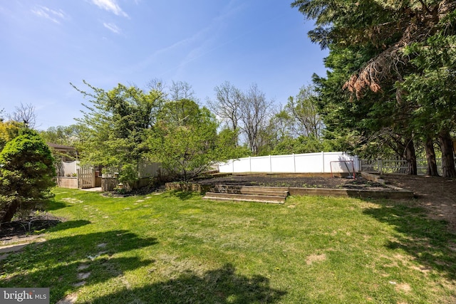 view of yard with a garden and fence