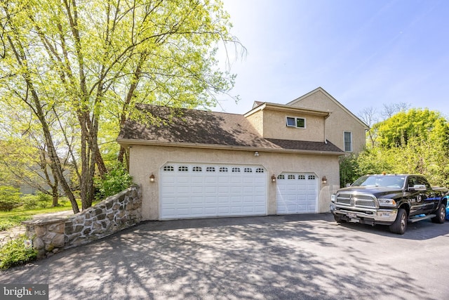 garage with aphalt driveway