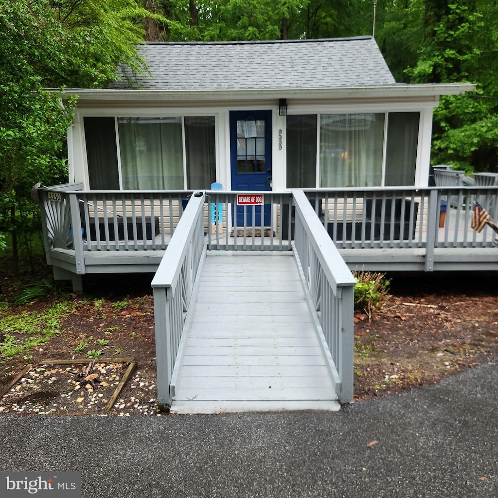 exterior space with roof with shingles