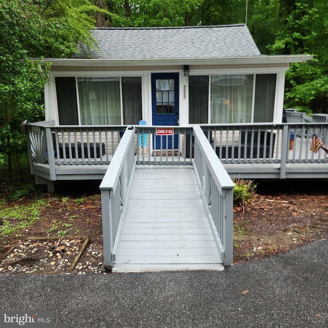 exterior space with roof with shingles