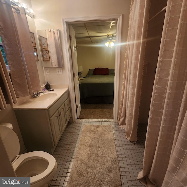 bathroom with a shower with curtain, toilet, tile patterned floors, connected bathroom, and vanity