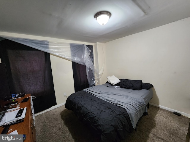 carpeted bedroom featuring baseboards