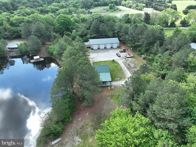 aerial view of property and surrounding area with a large body of water and a forest