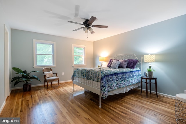 bedroom with baseboards and wood finished floors