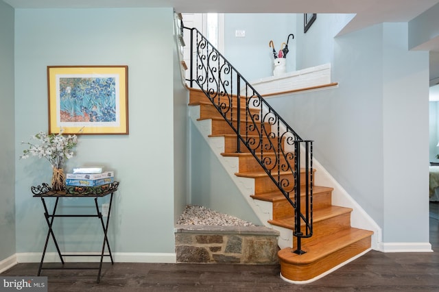 stairs with baseboards and wood finished floors