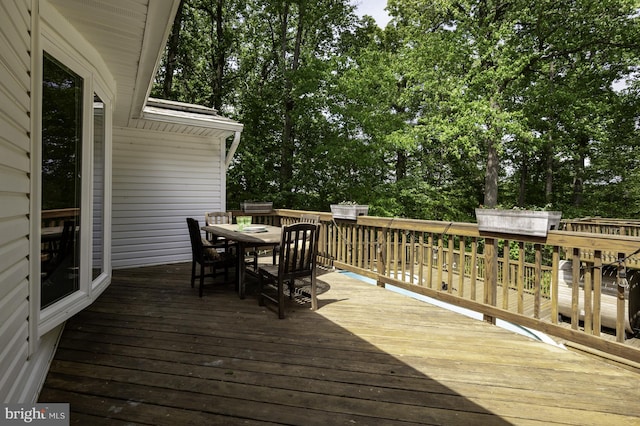 wooden terrace featuring outdoor dining area