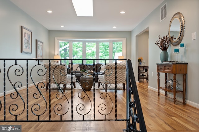 interior space featuring baseboards, recessed lighting, visible vents, and wood finished floors