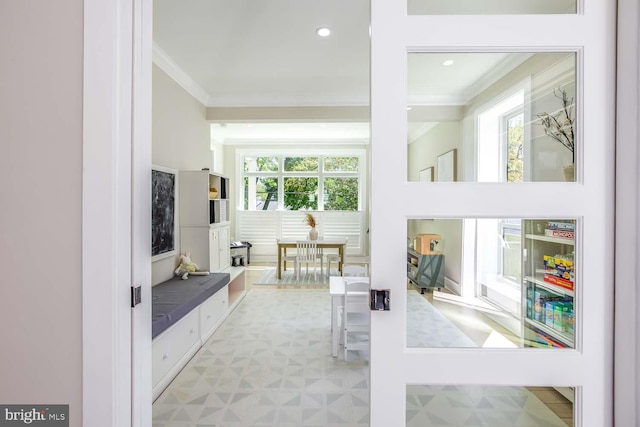 5116 Lawton Dr, Bethesda, MD 20816 - living area featuring crown molding, healthy amount of natural light, and light flooring