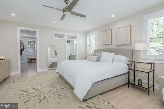 5116 Lawton Dr, Bethesda, MD 20816 - bedroom with multiple windows, a spacious closet, light wood-type flooring, and recessed lighting