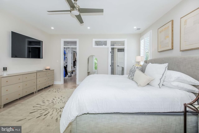 5116 Lawton Dr, Bethesda, MD 20816 - bedroom with a spacious closet, recessed lighting, ceiling fan, light wood finished floors, and a closet