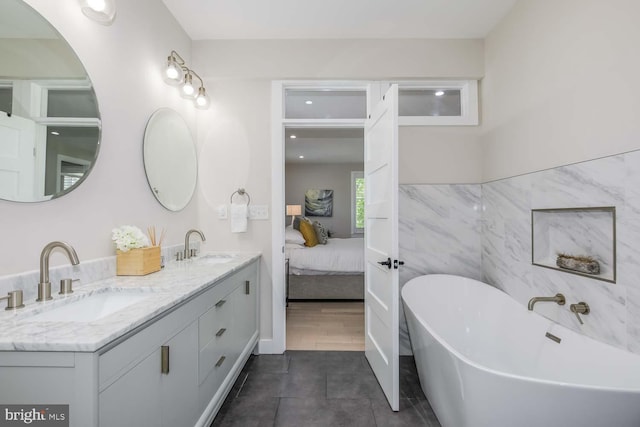 5116 Lawton Dr, Bethesda, MD 20816 - ensuite bathroom featuring a freestanding bath, double vanity, and tile patterned floors