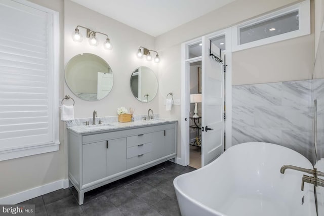 5116 Lawton Dr, Bethesda, MD 20816 - full bath featuring a freestanding tub, double vanity, and baseboards