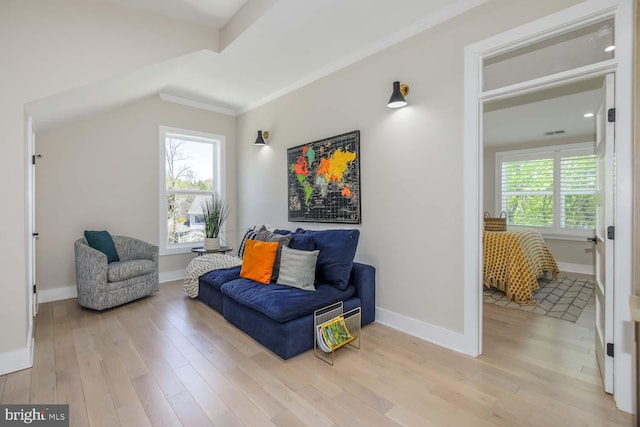5116 Lawton Dr, Bethesda, MD 20816 - living area featuring light wood finished floors, baseboards, lofted ceiling, and ornamental molding