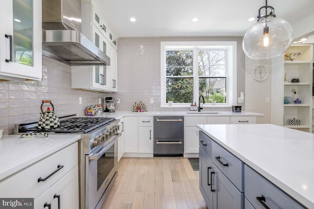 5116 Lawton Dr, Bethesda, MD 20816 - kitchen with stainless steel range, wall chimney exhaust hood, a sink, dishwashing machine, and backsplash