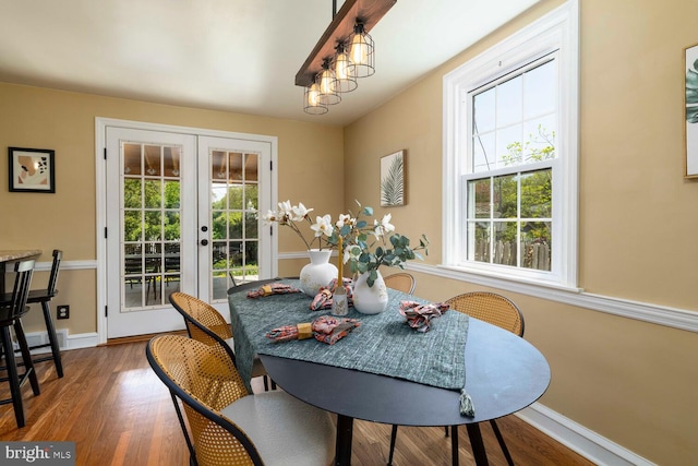 dining area featuring baseboards, french doors, a wealth of natural light, and wood finished floors