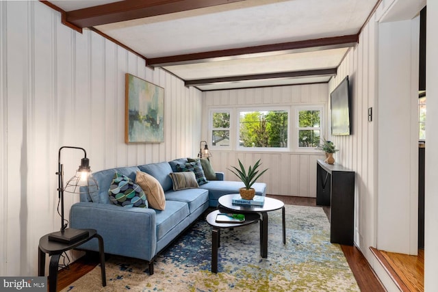 living room featuring wood finished floors and beamed ceiling
