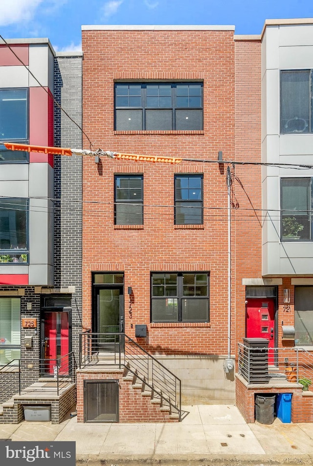 multi unit property with brick siding and cooling unit