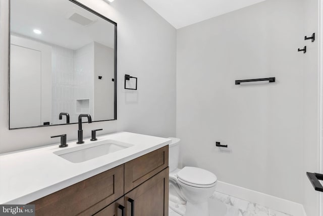 bathroom featuring baseboards, vanity, toilet, and marble finish floor