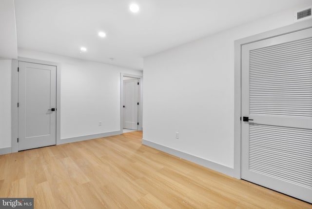 spare room featuring recessed lighting, baseboards, visible vents, and light wood-style flooring