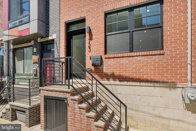 entrance to property with brick siding