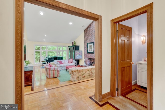hallway with vaulted ceiling and baseboards