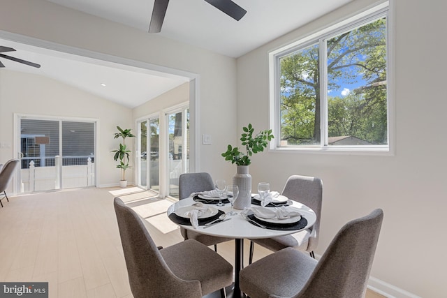 dining area with baseboards, ceiling fan, lofted ceiling, and a wealth of natural light