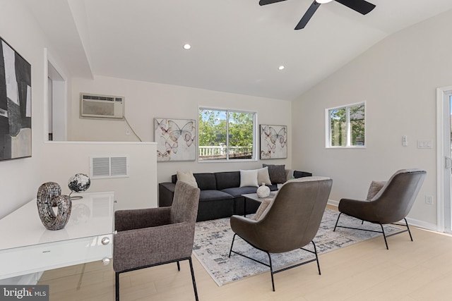 living area with ceiling fan, a wall mounted AC, a wealth of natural light, and vaulted ceiling