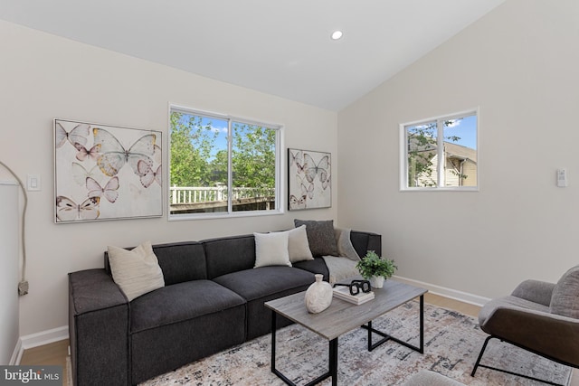 living room with baseboards, recessed lighting, lofted ceiling, and wood finished floors