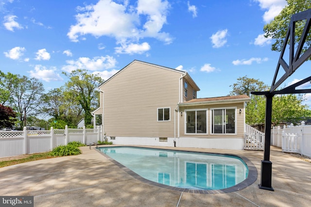 view of swimming pool with a fenced in pool, a fenced backyard, and a patio area