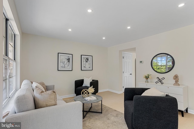 living room with plenty of natural light, recessed lighting, and baseboards
