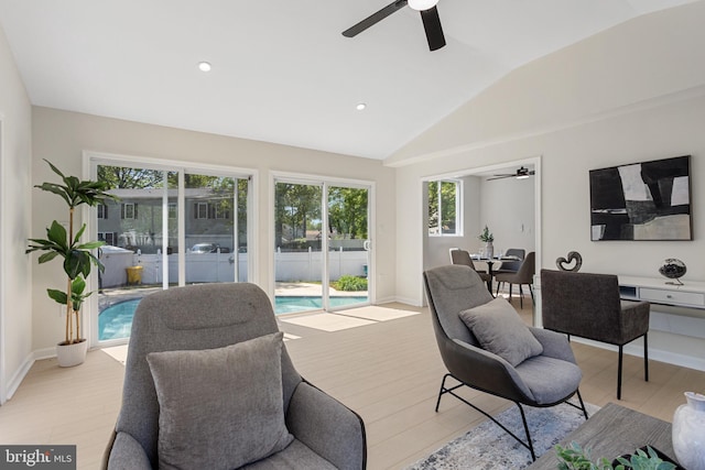 living room with light wood-type flooring, a ceiling fan, vaulted ceiling, and recessed lighting
