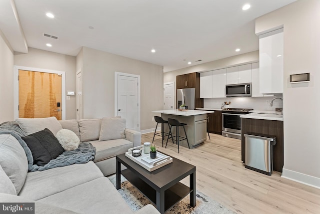 818 Kennedy St NW Unit 9, Washington, DC 20011 - living room with light wood-style flooring, baseboards, and recessed lighting