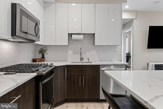 818 Kennedy St NW Unit 9, Washington, DC 20011 - kitchen with stainless steel appliances, a sink, modern cabinets, and white cabinets