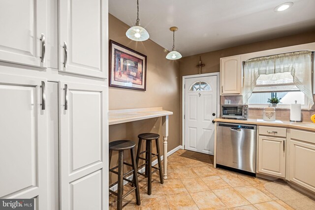 1223 Fitzgerald St, Philadelphia, PA 19148 - kitchen featuring dishwasher, light countertops, hanging light fixtures, and white cabinetry