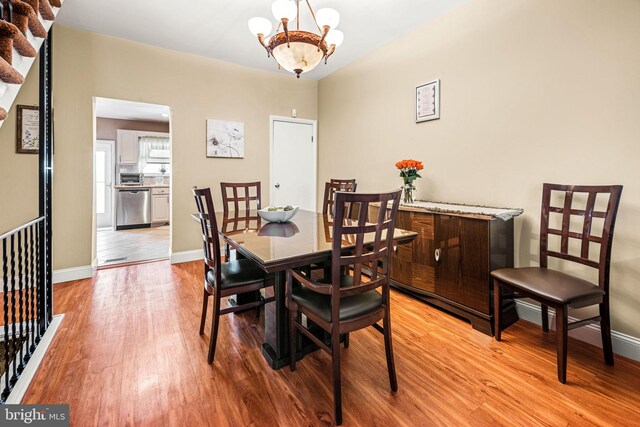 1223 Fitzgerald St, Philadelphia, PA 19148 - dining area with light wood-type flooring, a chandelier, and baseboards