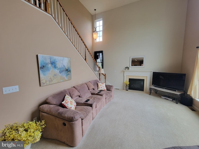 402 Waltham Dr, Middletown, DE 19709 - carpeted living area featuring baseboards, a fireplace with flush hearth, a high ceiling, and stairway