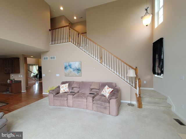 402 Waltham Dr, Middletown, DE 19709 - carpeted living area featuring a high ceiling, stairs, and visible vents