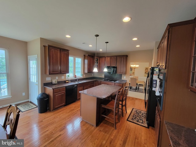 402 Waltham Dr, Middletown, DE 19709 - kitchen featuring a sink, a center island, black appliances, and light wood finished floors