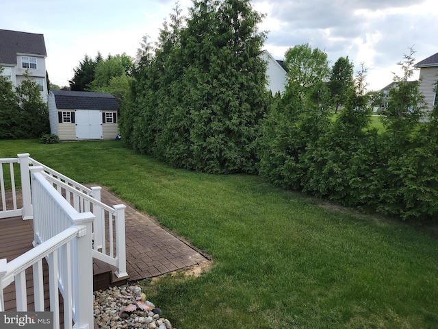 402 Waltham Dr, Middletown, DE 19709 - view of yard featuring a wooden deck, a storage unit, and an outbuilding