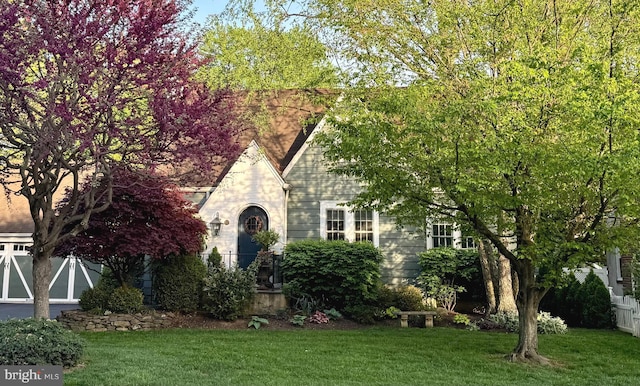 tudor home with a front yard