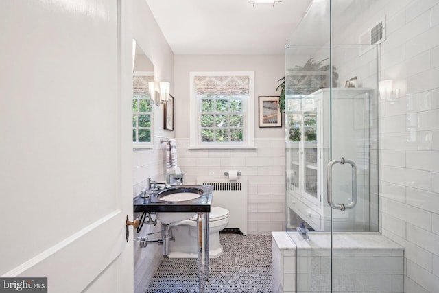 835 Beechwood Rd, Havertown, PA 19083 - full bath with radiator, tile walls, a stall shower, tile patterned floors, and toilet
