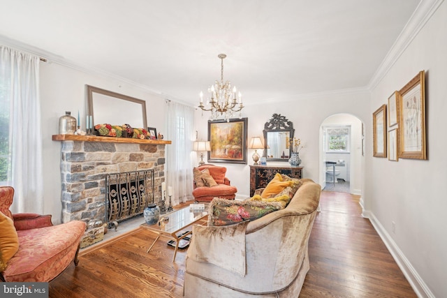 835 Beechwood Rd, Havertown, PA 19083 - living area featuring arched walkways, a fireplace, wood finished floors, ornamental molding, and a chandelier
