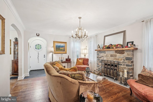 835 Beechwood Rd, Havertown, PA 19083 - living room with arched walkways, ornamental molding, wood finished floors, a fireplace, and a chandelier