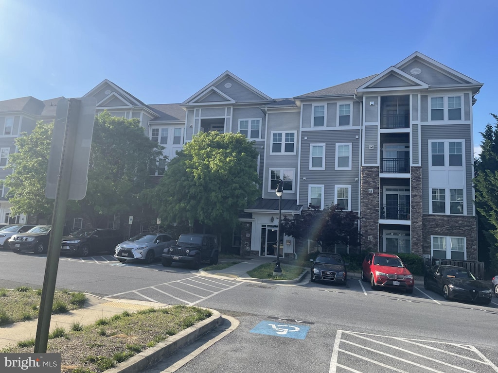 1321 Karen Blvd Unit 306, Capitol Heights, MD 20743 - view of building exterior featuring uncovered parking